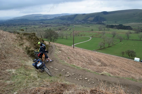 Dillan taking in the views to Castleton on the Barker Bank climb to Hollins Cross