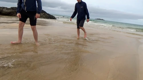 Walking back along the beach stream at Harlyn Bay towards the mini-rapids John successfully negotiated.