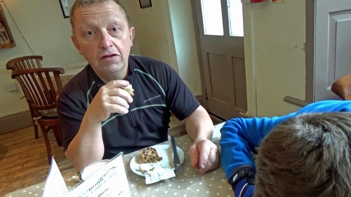 John unimpressed at cheese with his cake, Reading Room Café, Clapham