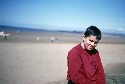 Neil Allan on Marine Parade, Instow, with the beach and Taw estuary behind.