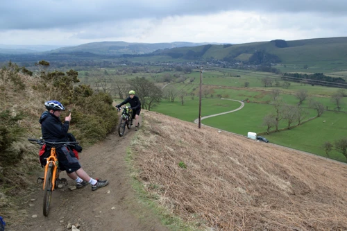 Dillan admires views back to Castleton on the Barker Bank climb to Hollins Cross