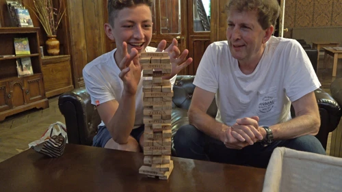 George scrapes through another Jenga turn with Michael in the Great Hall, Langdale YHA.