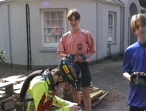 Julian tweaks Matthew’s helmet for a safer ride.