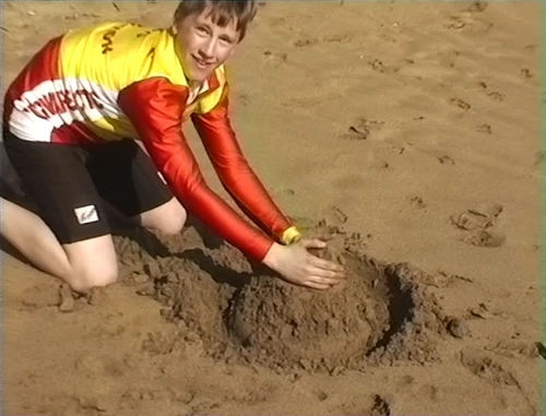 Jered tries his hand at sandcastle building, Hemmick Beach, Boswinger.