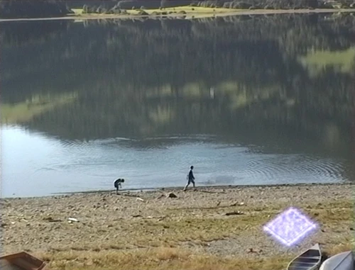 Children skim stones on Voss lake, seen from the youth hostel.