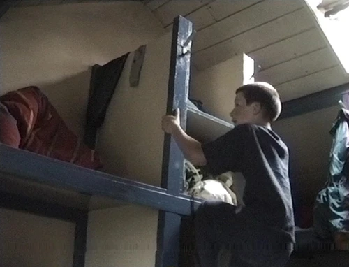 The first floor dorm at Bryn Poeth Uchaf youth hostel is so compact that the only way Alasdair can reach his top bunk is to climb the built-in storage shelves