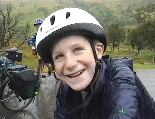 Alasdair as cheerful as ever despite the unpleasant weather, although his good spirits are partly due to the generosity of Luke and Llewellyn in carrying his panniers