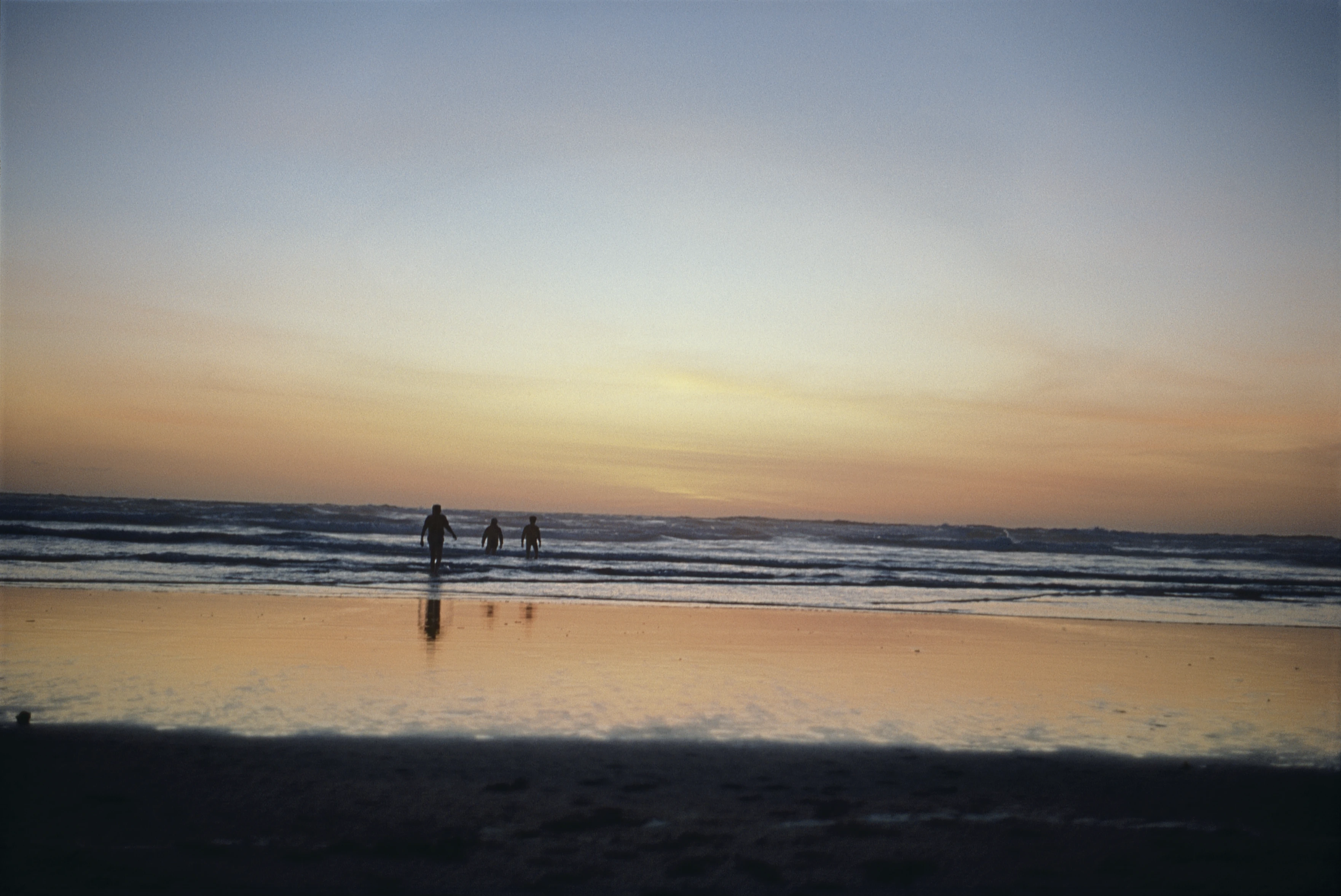 Three of our youngsters take a final dip in the sunset waters at Perranporth Beach