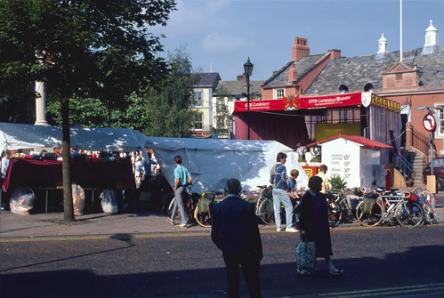 31 Aug 1987 · Chris, Jeff, Michael and Stephen browse Carlisle's Bank Holiday market by the Market Cross.