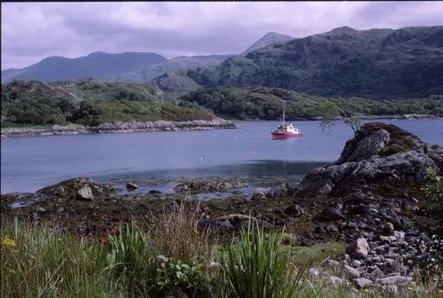 21 Aug 1988 · Converted wooden motor cruiser on Loch nan Uamh in afternoon sun, viewed from near the Prince's Cairn.