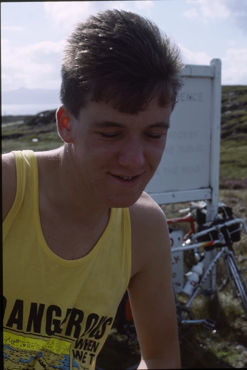 25 Aug 1988 · Michael Hall at the MoD sign for the BUTEC shore road, Sand Beach.