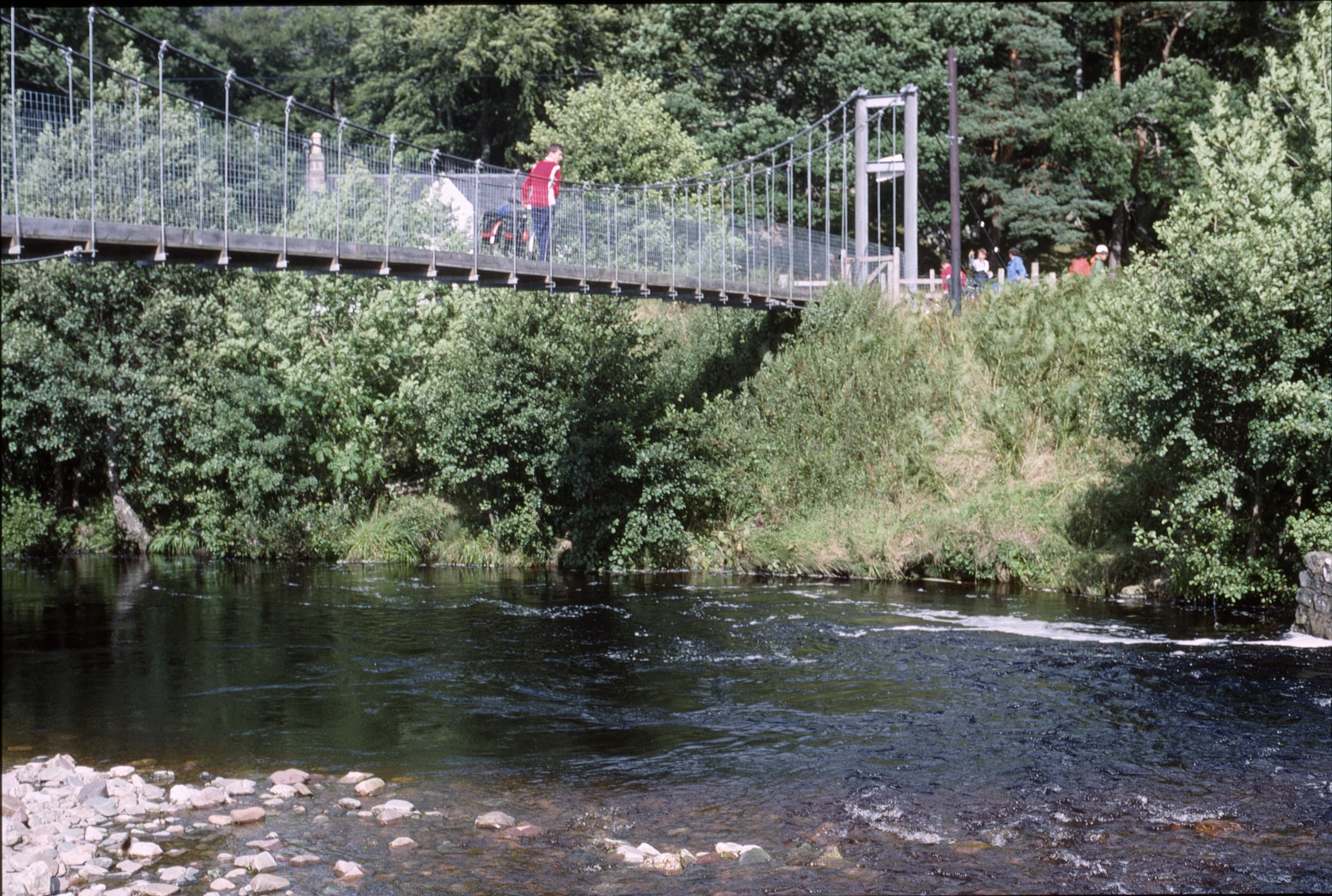 Chris Hall crossing the footbridge over the Dundonnell River, heading for the road climb.