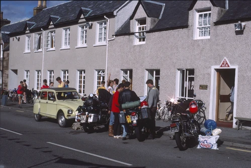 28 Aug 1988 · The gang outside Ullapool Youth Hostel on Shore Street, sunlit and ready to roll.