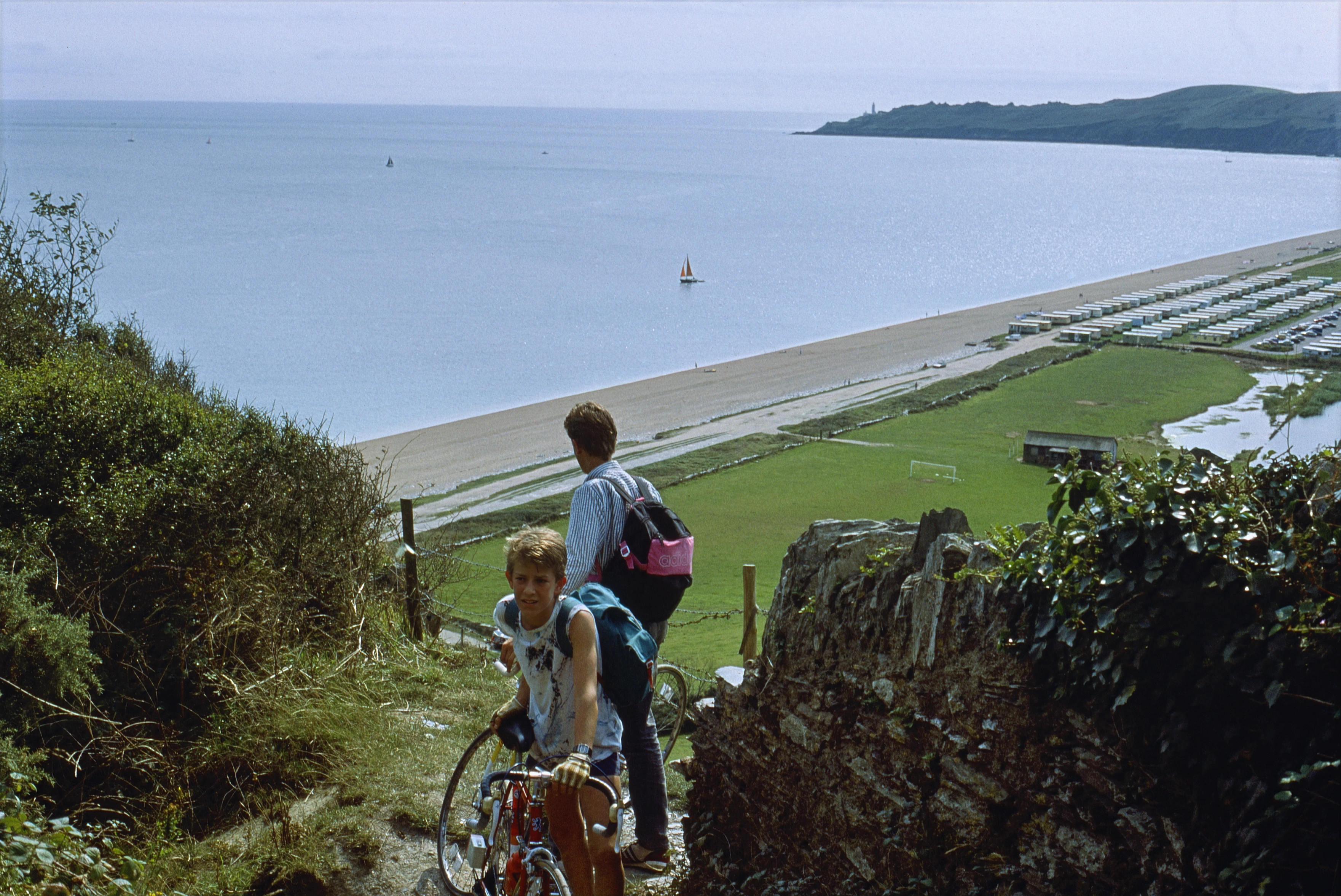 Mark and Paul Lakeman push up the steep coast path from Beesands towards Torcross, Start Point beyond.