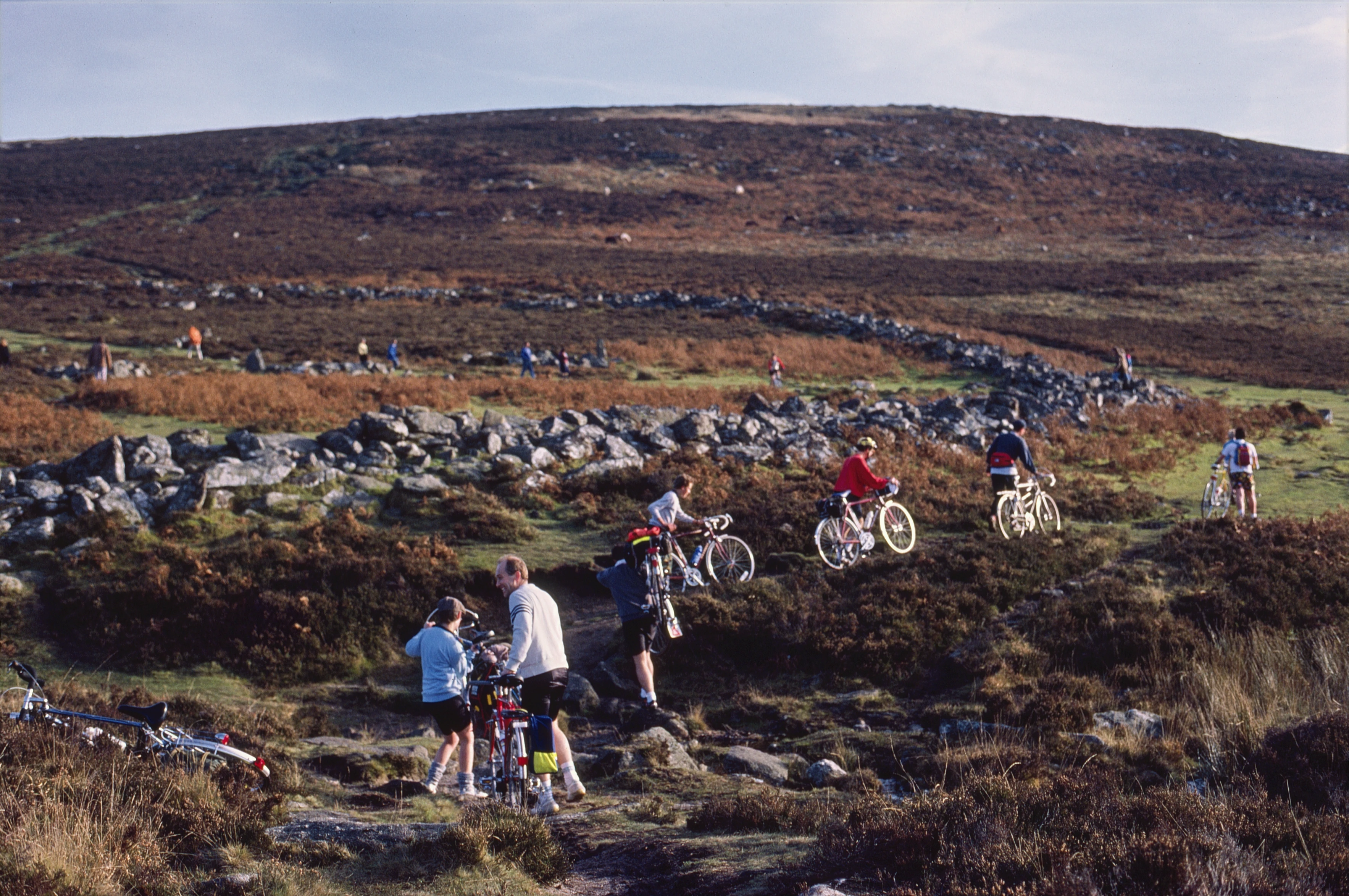 Ken and the others pick their way towards Grimspound, hillside climb ahead.
