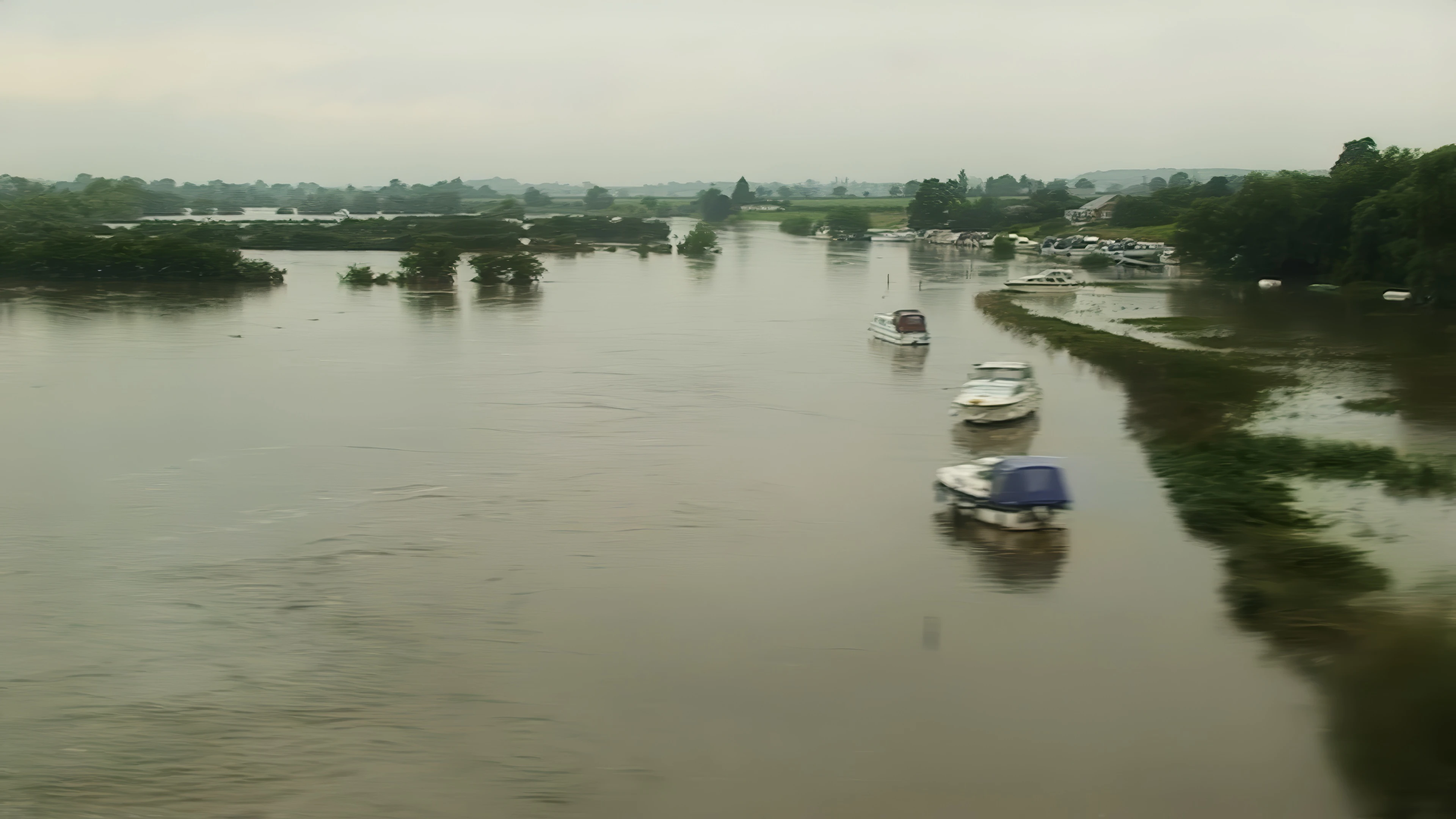 River Avon in full flood at Defford Marina; overnight deluge crippled the railways.