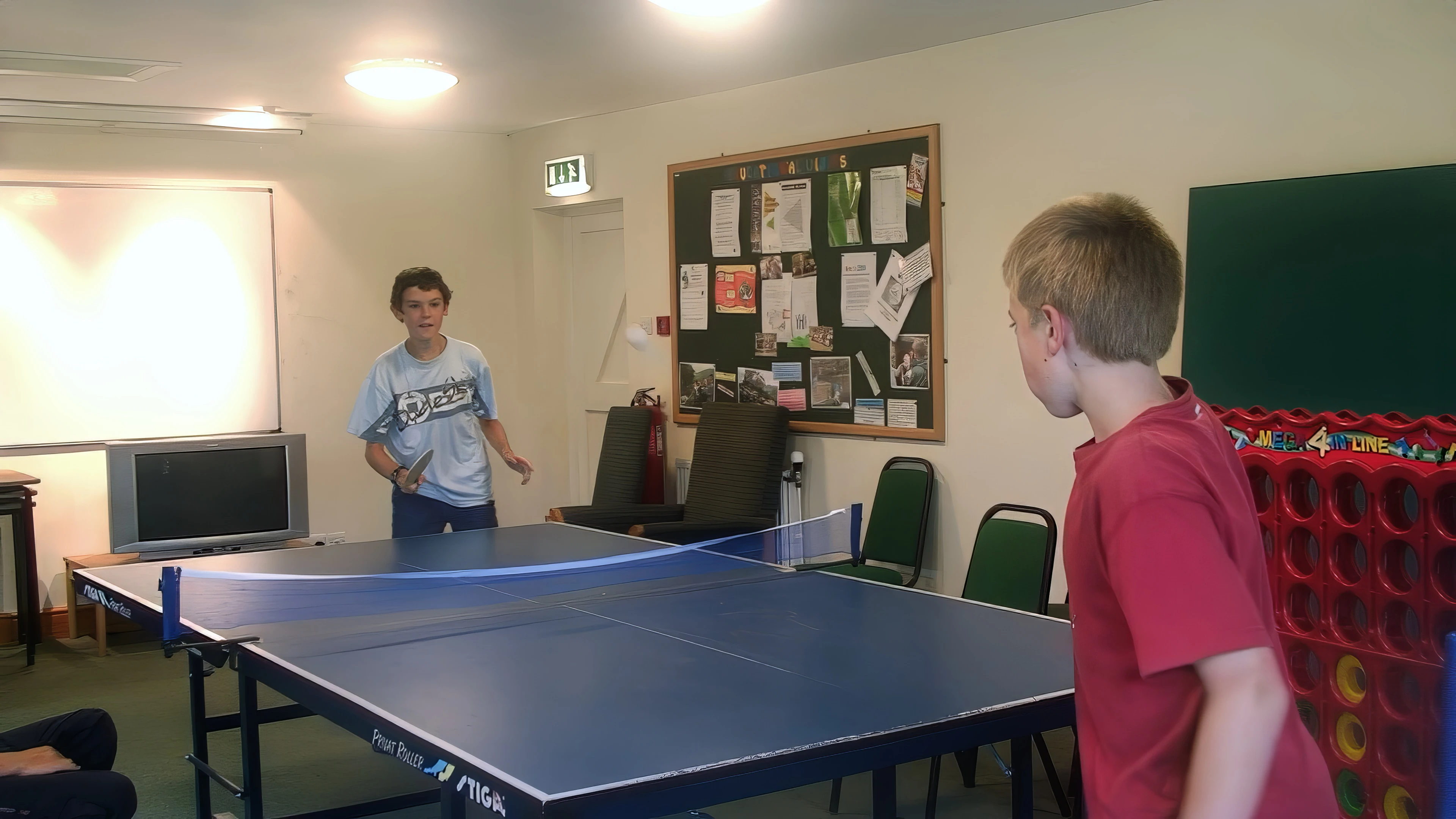 Freddie attempts to prove table-tennis supremacy in Borrowdale YH games room.