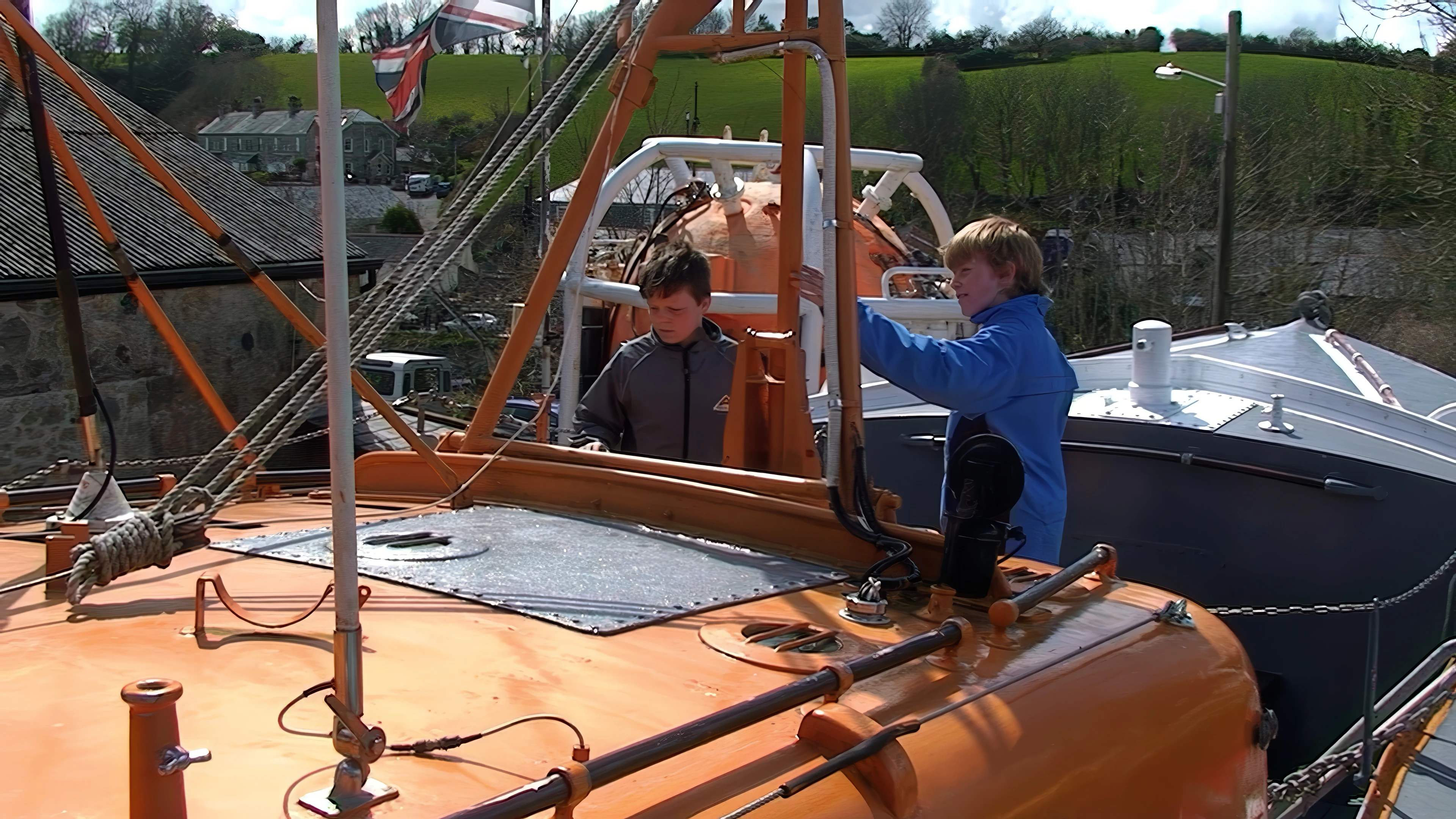 Ash and Olly on the lifeboat at the Shipwreck Heritage Centre, Charlestown.