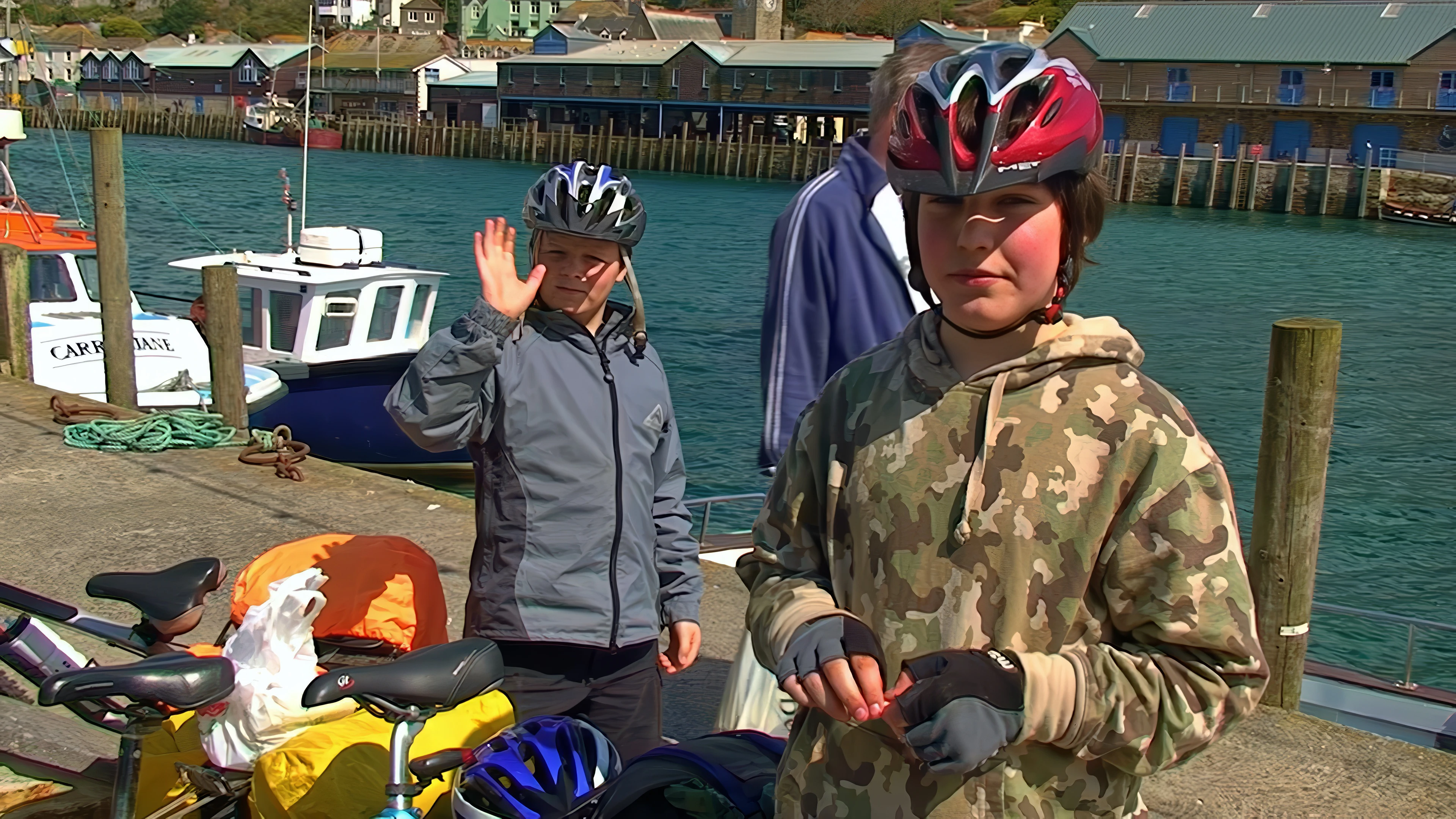 Ash and Zac at West Looe Quay, ready to enter the Tasty Corner Café — 13.6 miles in.