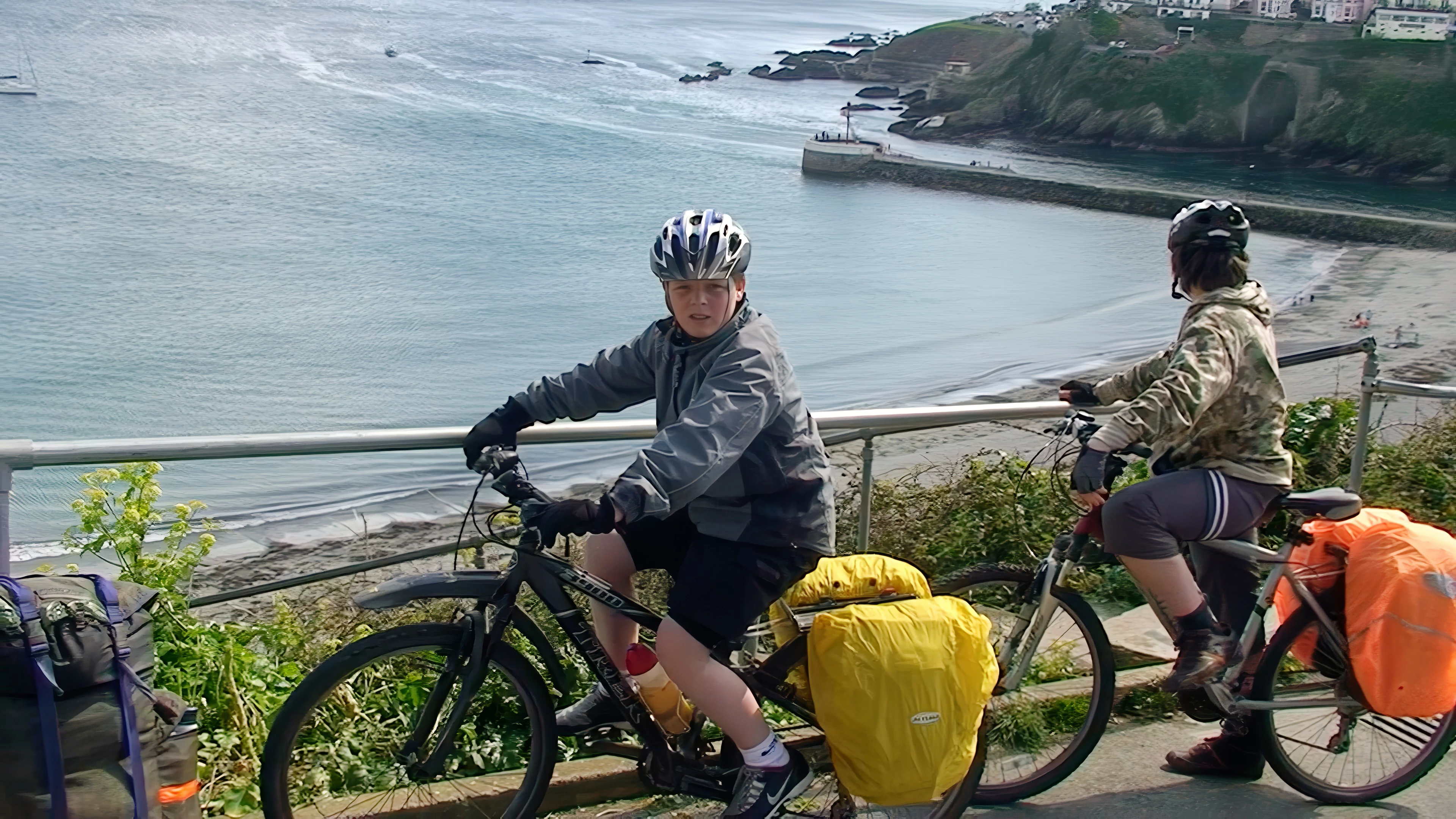 Ash and Zac on East Cliff, Looe, after climbing out of town — 14.3 miles in.