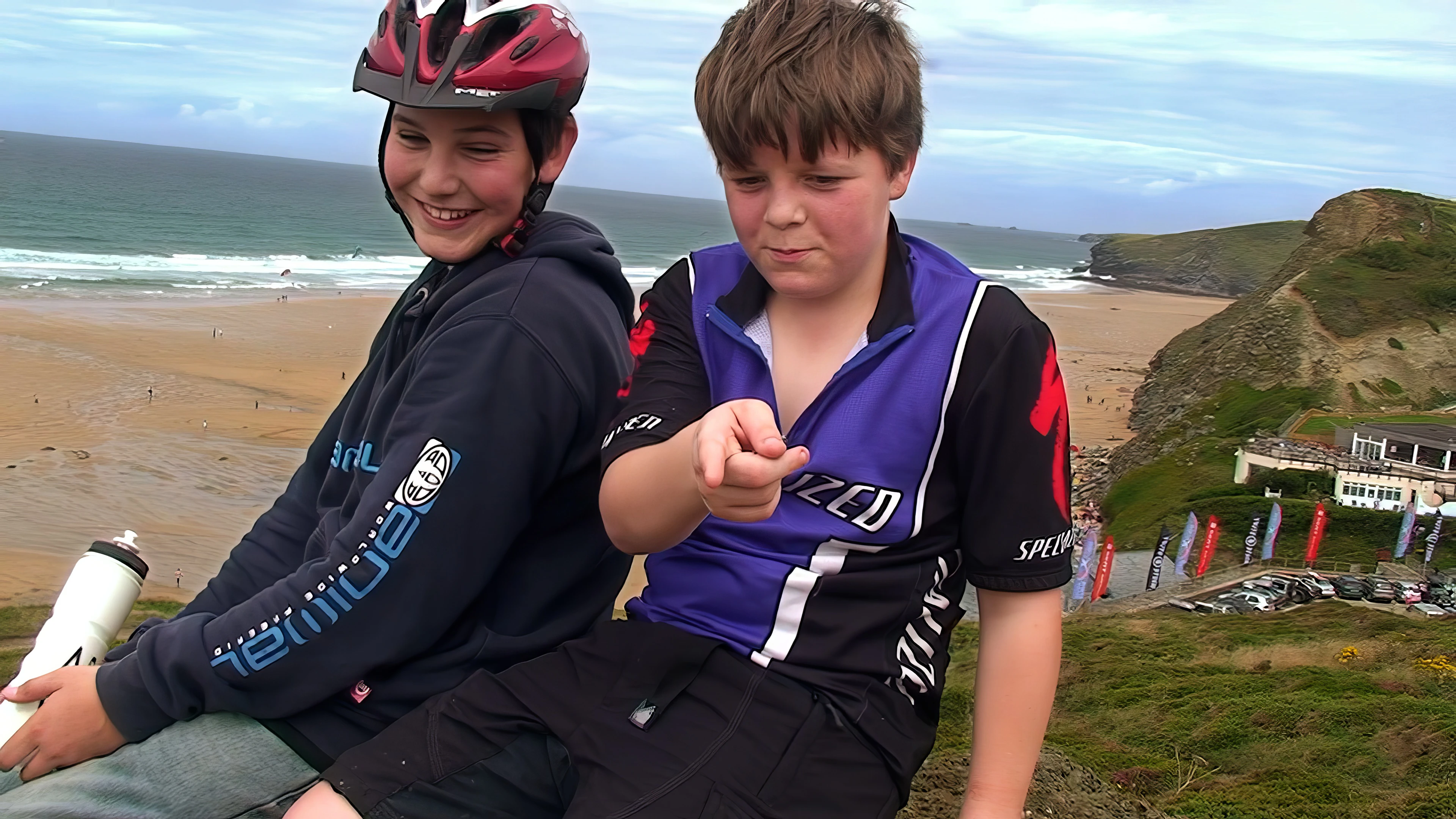 Zac and Ash take a well-earned rest overlooking Watergate Bay, 7.8 miles into the ride.