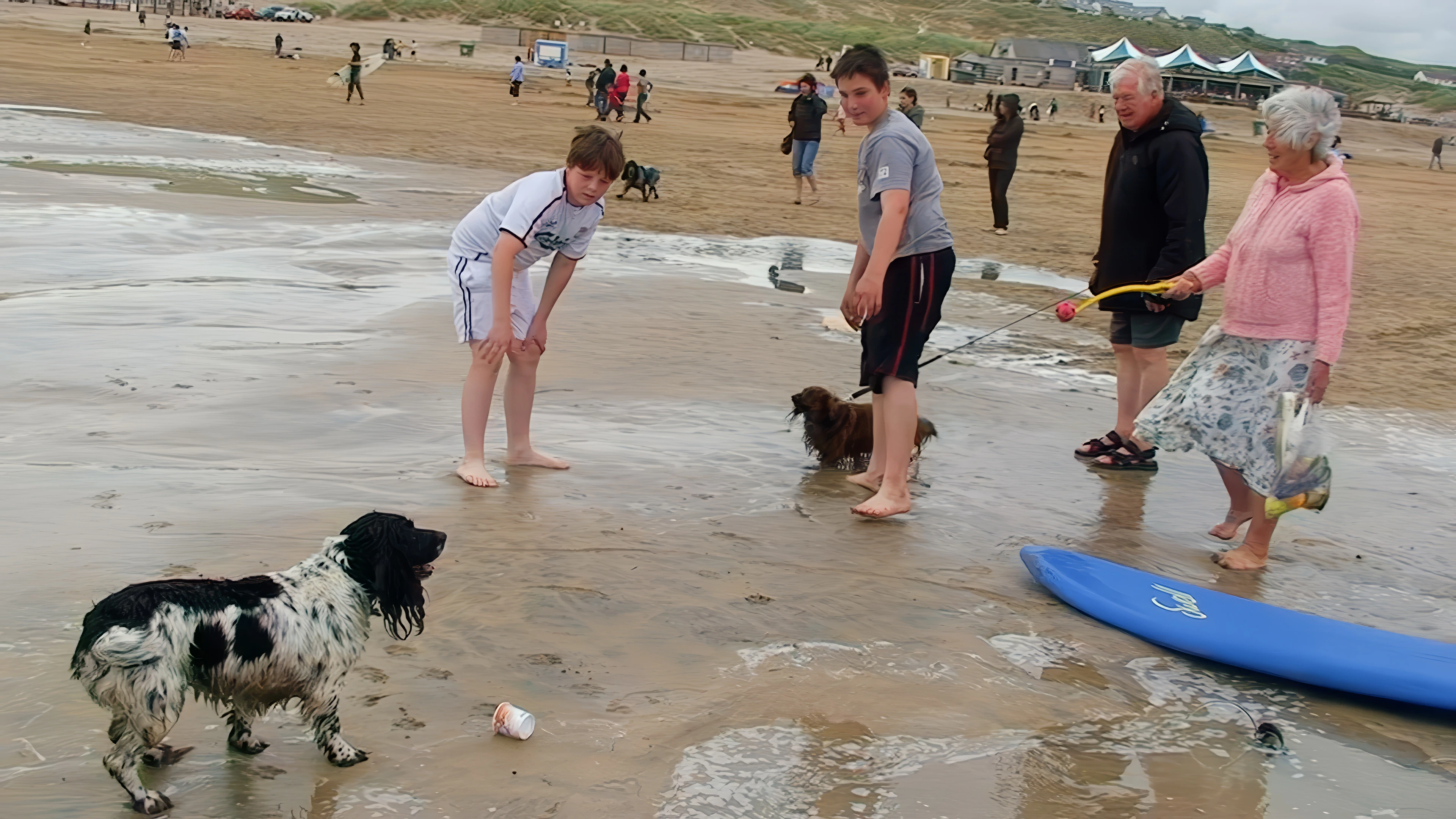 Ash and Zac chat with a couple and their two delightful dogs on Perranporth Beach.