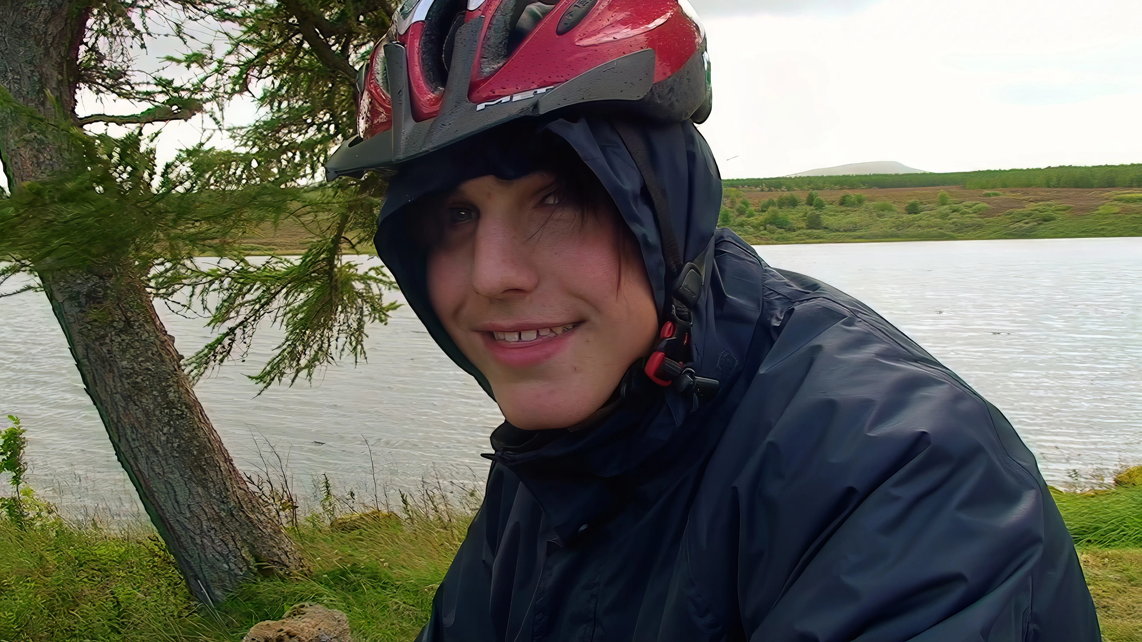 Zac outside the Altnacealgach Inn after lunch, with Loch Borralan behind